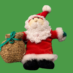 Cute soft & fuzzy Santa ornament! Santa has a curly beard and burlap sack.